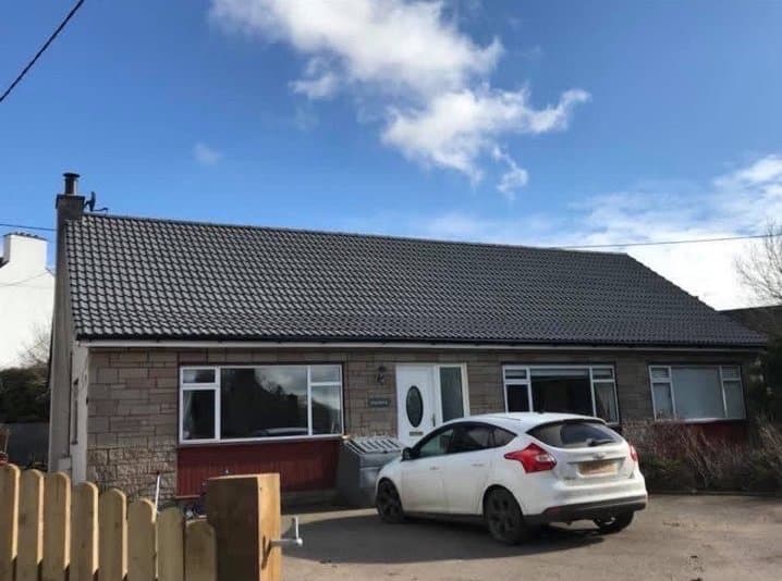Bungalow with a completed new dark tile roof