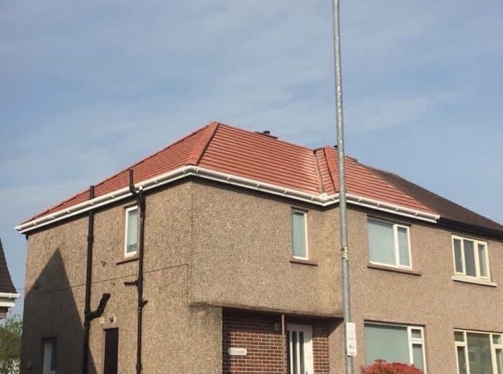New guttering and white fascias on a re-roofed house